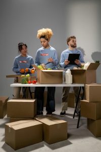 Diverse group of volunteers organizing food donations indoors.